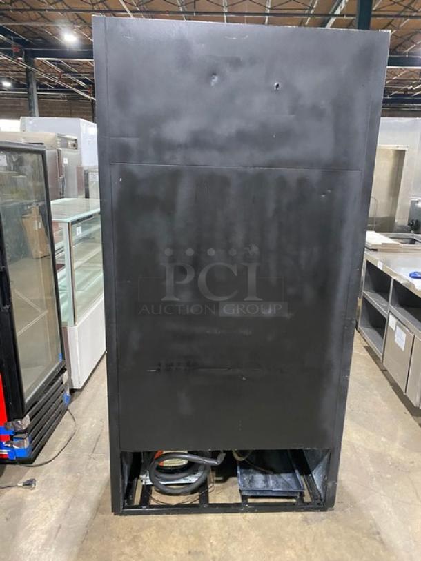 True GDM-33 black reach-in merchandiser refrigerator, glass sliding doors, poly-coated wire racks, 115V, 1-phase, used condition.