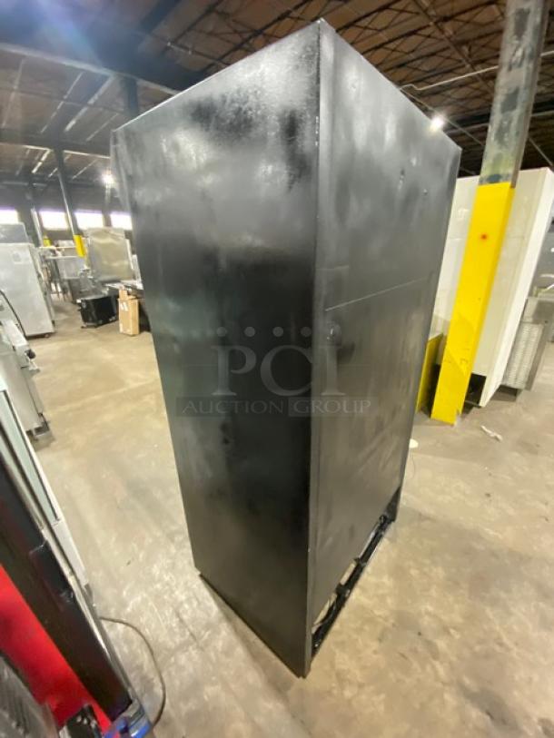 True GDM-33 black commercial refrigerator, double glass sliding doors, poly-coated wire racks, in fair condition.