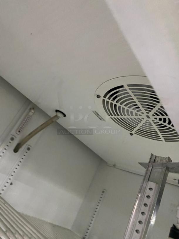 True Commercial Refrigerator, Model GDM-33, showing interior with poly-coated wire racks and cooling fan. Serial: 1-3340720.