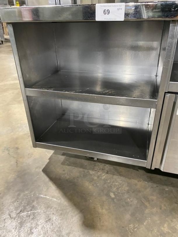 Custom stainless steel single door refrigerated prep table with enclosed storage shelves on casters. Item tag: 69.