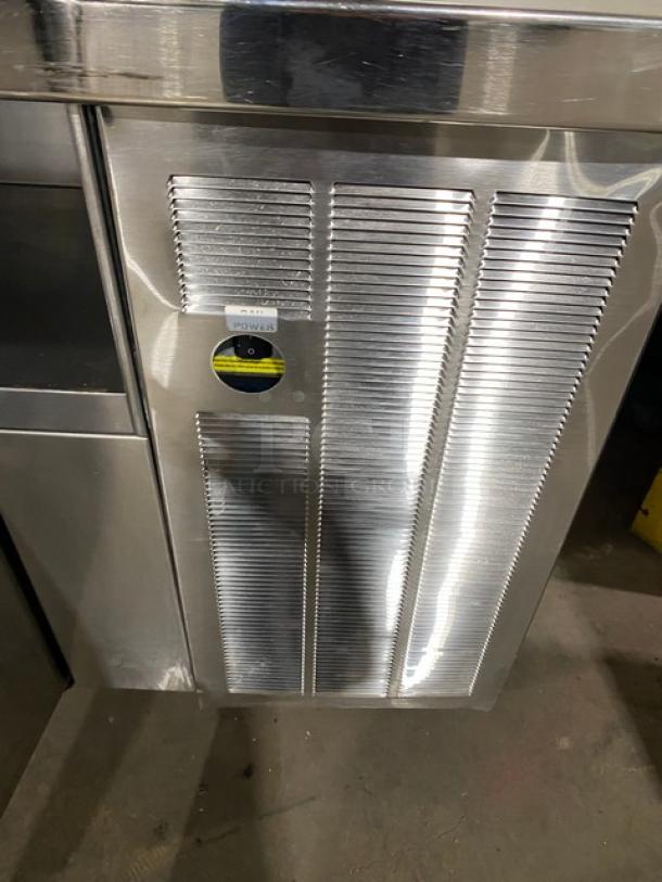 Custom stainless steel single door refrigerated prep table with enclosed storage shelves, on casters, durable build.