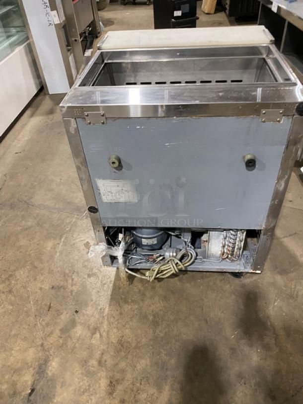 Turbo Air TST-28SD commercial stainless steel single door refrigerated salad/sandwich prep table with cutting board, 115V, on casters, rear view showing compressor and cabling.