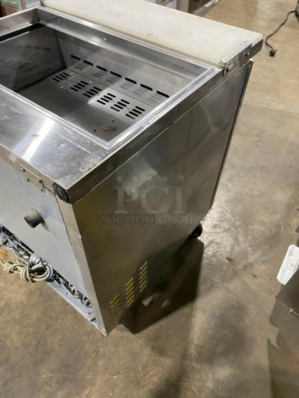 Turbo Air TST-28SD stainless steel refrigerated prep table with cutting board, on casters, shown in used condition.