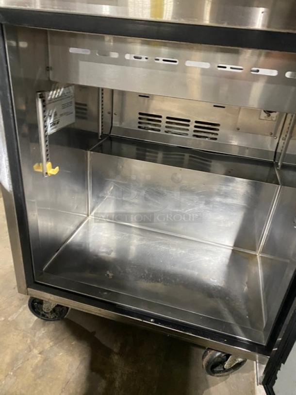Turbo Air TST-28SD stainless steel refrigerated prep table with cutting board, single door, on casters, 115V, interior view.