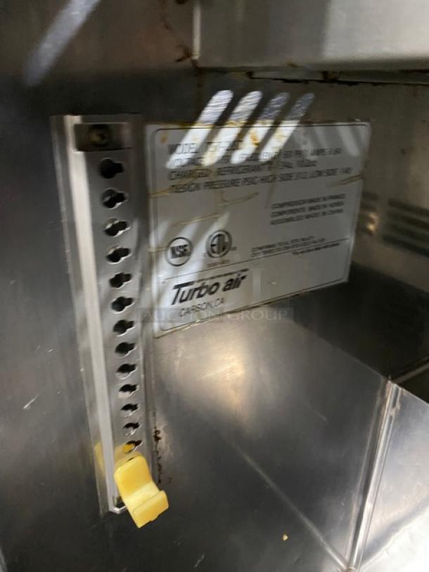 Turbo Air TST-28SD stainless steel refrigerated prep table, single door, with cutting board, on casters, label visible.