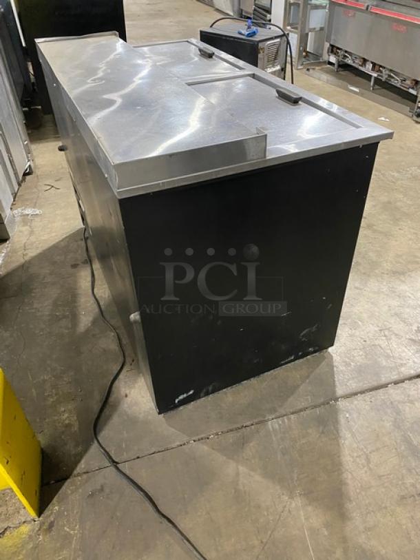 Fogel BC-50DBST commercial black powder coated back bar cooler with stainless steel top, double sliding lids, and visible wear.
