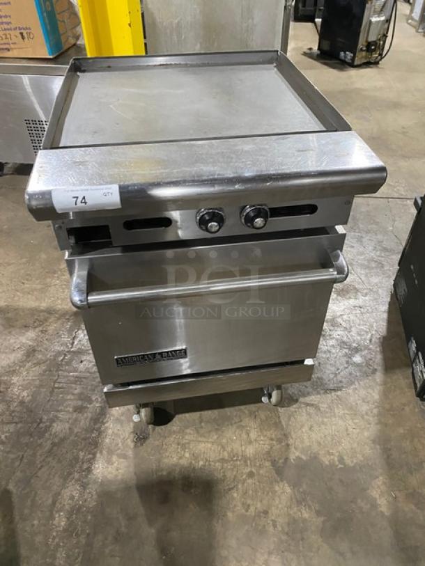 American Range stainless steel flat top range/oven combo, natural gas powered, with wired oven rack, on casters, good condition.