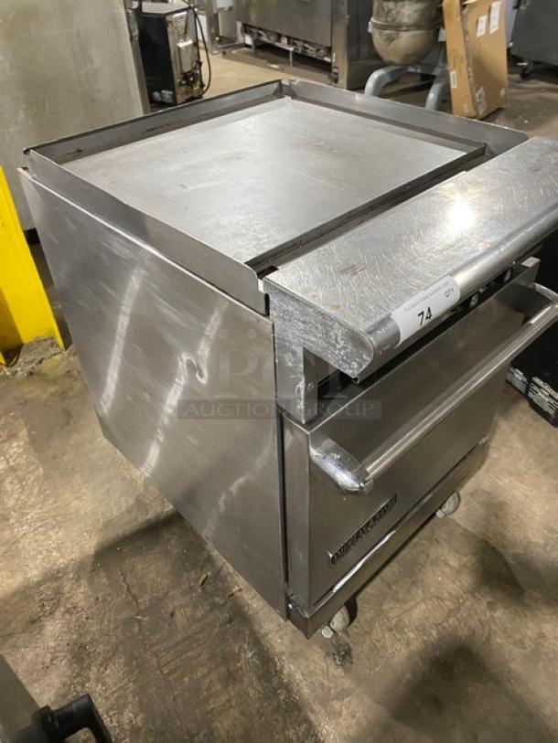 American Range stainless steel flat top range/oven combo, natural gas powered, with wired oven rack, on casters, used condition.