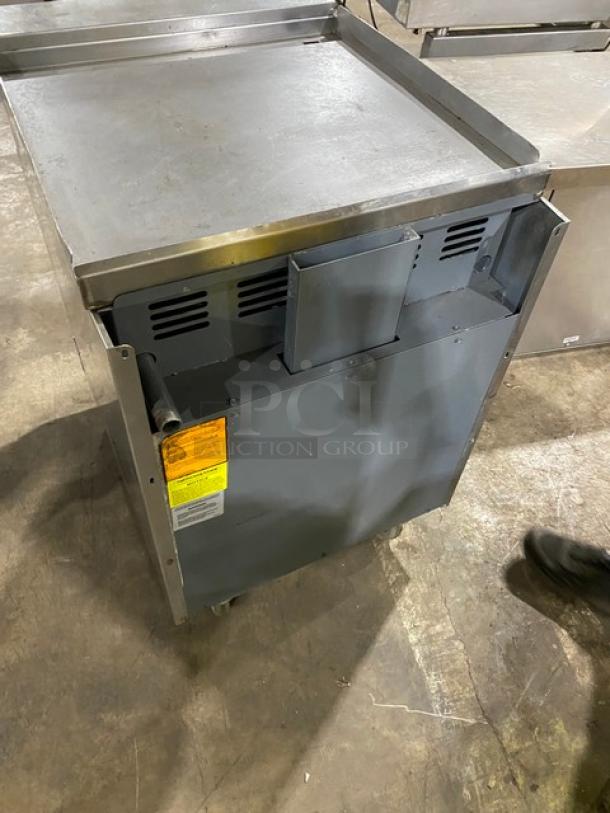 American Range stainless steel flat top range/oven combo on casters. Natural gas. Wired oven rack. Labels visible.
