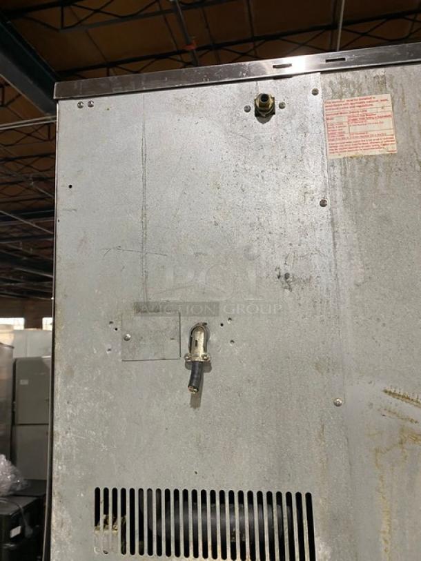 Hoshizaki KM-1340MWH stainless steel ice machine, water-cooled, with top condensing unit. Model and serial number visible.