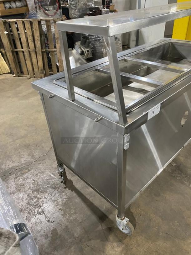 Atlas Metal WH-4 stainless steel 4-well hot food steam table on casters, with serve-over sneeze guard, in used condition.