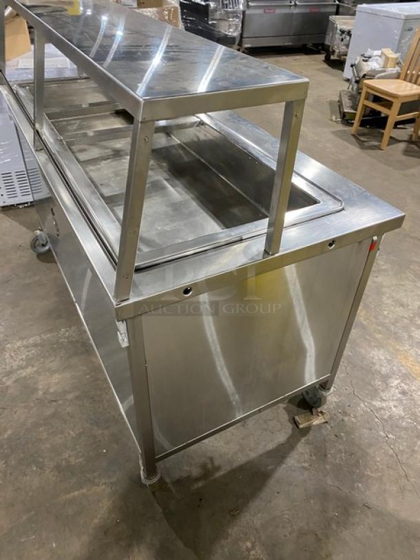 Atlas Metal WH-4 stainless steel electric 4-well hot food table with sneeze guard, 1 phase, on casters, in good condition.