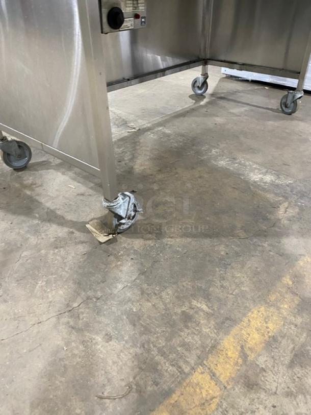 Atlas Metal WH-4 stainless steel 4-well steam table with sneeze guard and casters, electric, 1 phase, commercial use.