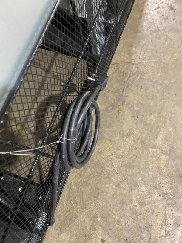 Close-up of a coiled power cord attached to the back of a Maxx Cold MXM2-48R refrigerator.