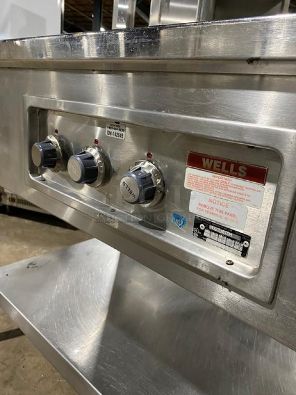 Wells MOD300TDM stainless steel 3-well hot food table, electric-powered, with single undershelf, visible control panel, on legs.