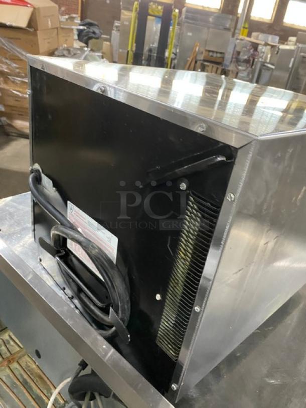 Amana RC30S2 commercial stainless steel microwave, 2014 model, electric, programmable touchpad, visible serial label, rear view.