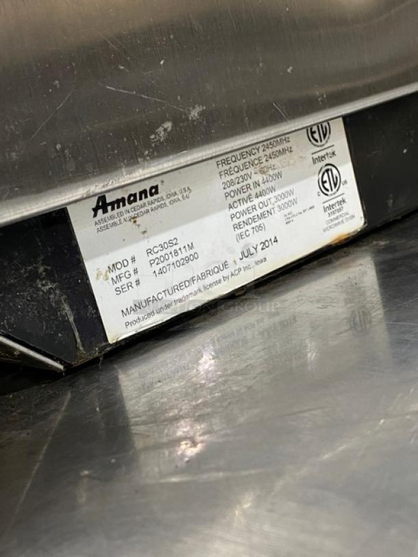 Amana 2014 commercial stainless steel microwave oven, model RC30S2, with programmable touchpad, 208/230V. Serial: 1407102900.