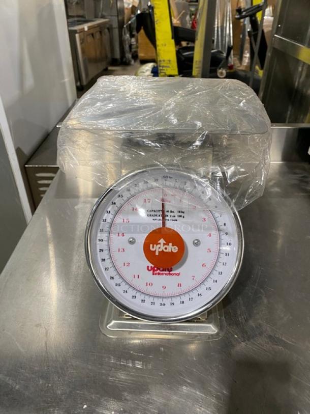 Brand new Update International UPS-840 stainless steel 40 lb. countertop scale with 8" analog dial, clear markings, and protective wrap.