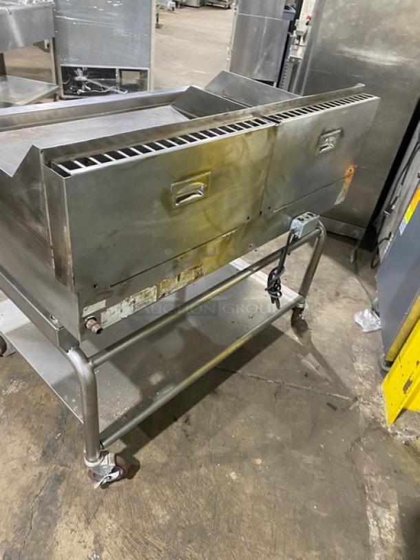 WoodStone stainless steel natural gas countertop plancha flat griddle, with back and side splash, on undershelf cart with casters.