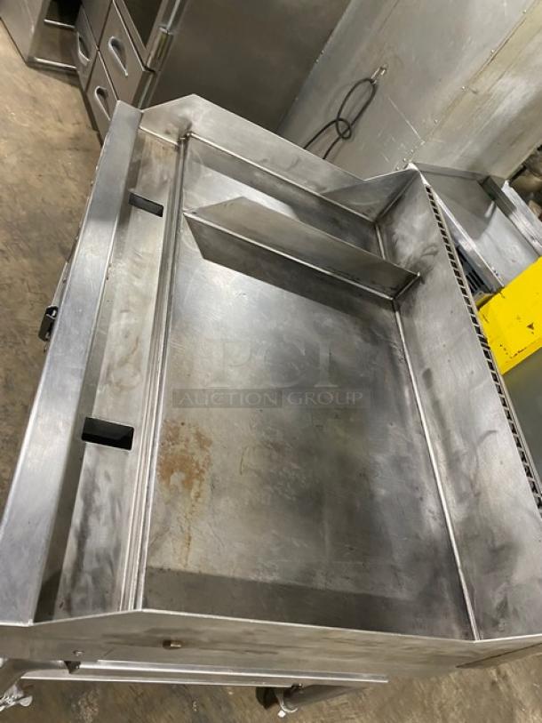 WoodStone stainless steel natural gas countertop plancha griddle with back and side splash, includes cart with undershelf on casters.