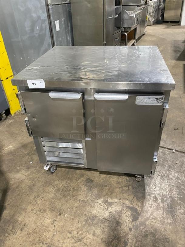 Leader LB36SC stainless steel 2-door refrigerated worktop lowboy with wired rack. Serial: PT010646a. On casters, 115V 1-phase.