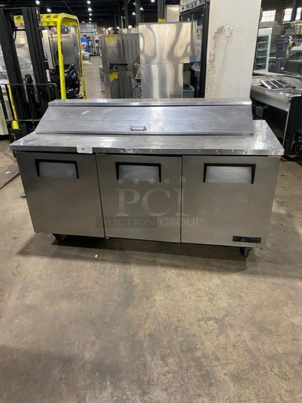 True TSSU-72-18 stainless steel refrigerated prep table, three doors, bain marie style, on casters, 115V, model tag visible.