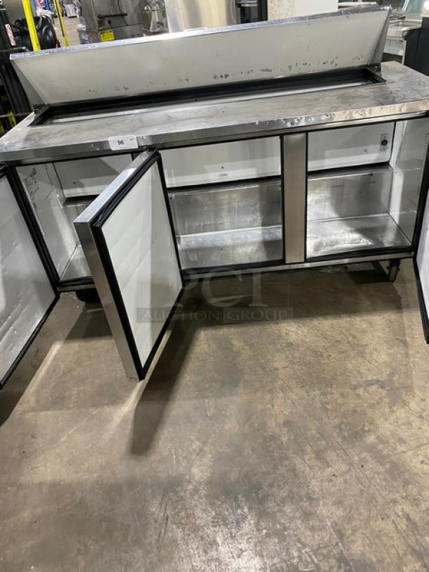 True TSSU-72-18 refrigerated prep table with 3 doors, stainless steel, excellent condition, on casters, accommodates salads/sandwiches.