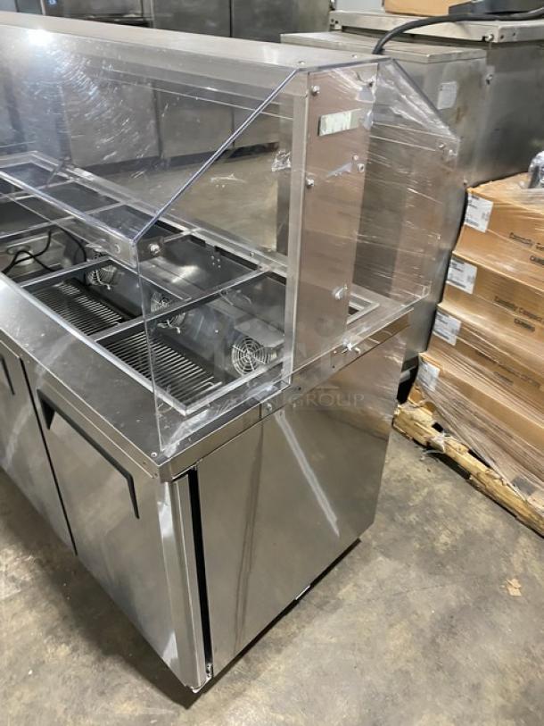 Turbo Air JBT-72-N stainless steel 3-door refrigerated buffet table with sneeze guard and wire racks, on casters, 115V.