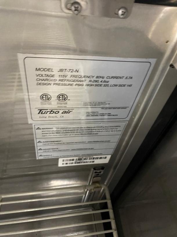 Turbo Air JBT-72-N model tag, 115V, 5.7A. Features include poly coated wire racks and ETL certification.