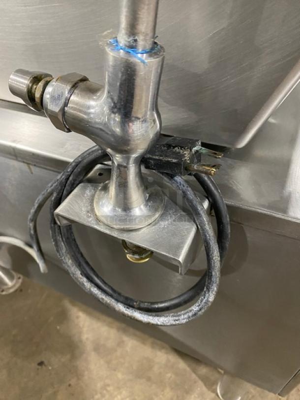 Cleveland Range stainless steel electric tilt skillet with single spout faucet on sturdy legs, in used condition.