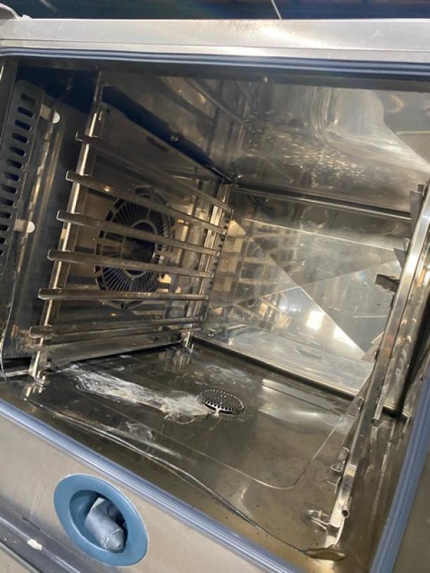 Rational SCC62G SelfCooking Center, stainless steel, natural gas, double-stacked combi oven, wired racks, blue gas hose.