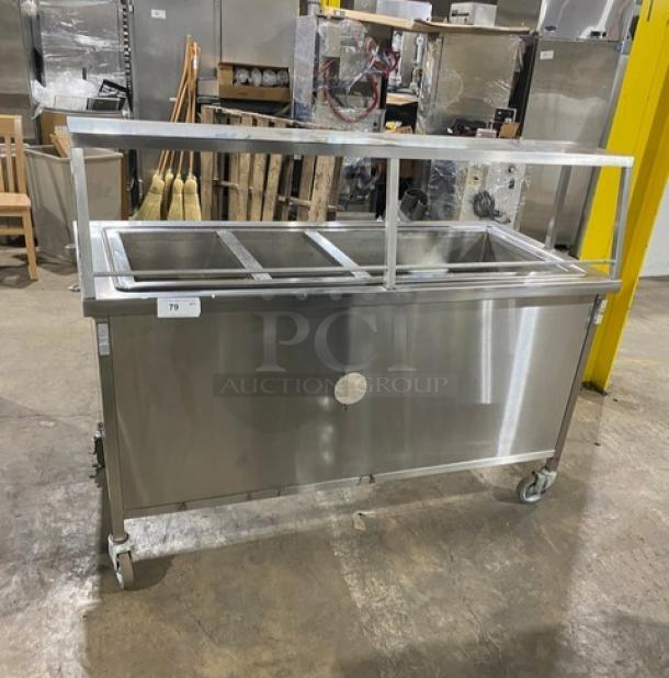 Atlas Metal Model WH-4 stainless steel electric 4-well hot food/steam table with sneeze guard, 1 phase, on casters.