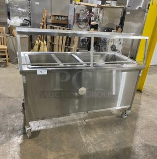 Atlas Metal Model WH-4 stainless steel electric 4-well hot food/steam table with sneeze guard, 1 phase, on casters.
