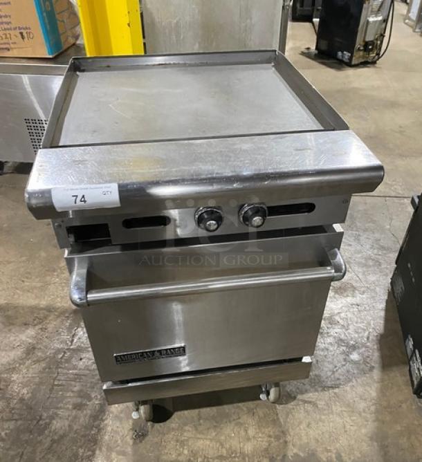 American Range stainless steel flat top range/oven combo with wired oven rack, natural gas, on casters, tag 74 visible.