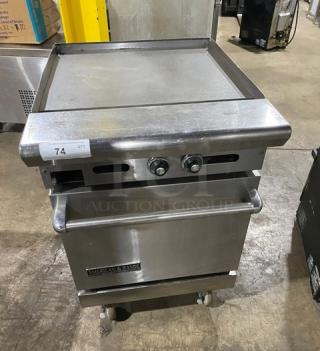 American Range stainless steel flat top range/oven combo with wired oven rack, natural gas, on casters, tag 74 visible.