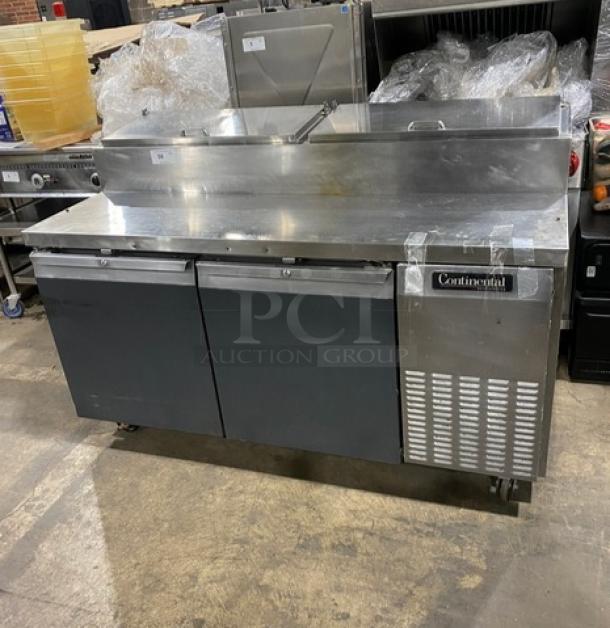 Continental CPT67-SS 2 Door Refrigerated Pizza Prep Table with backsplash, poly coated wire racks, and casters.