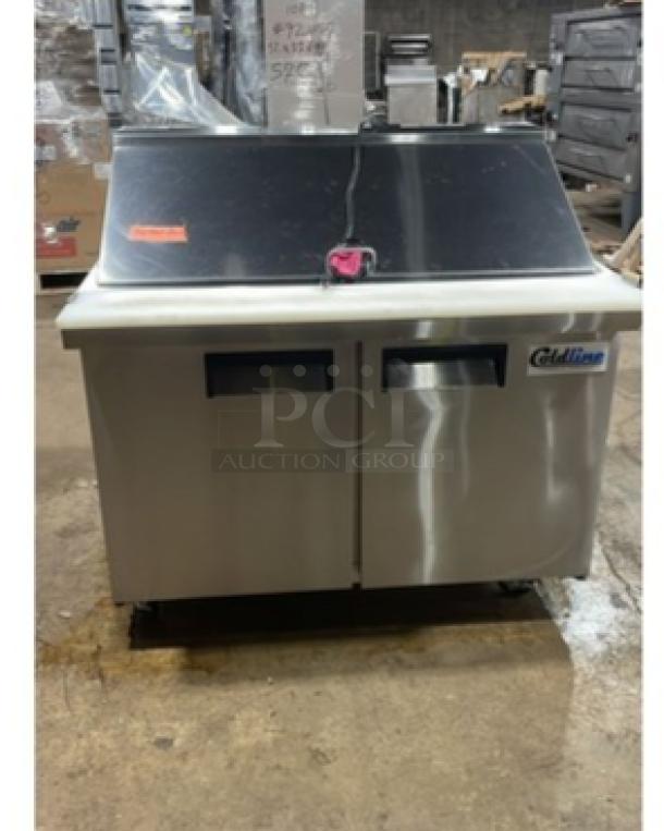 ColdLine commercial stainless steel 2-door refrigerated prep table with removable cutting board and clear food pans, on casters.