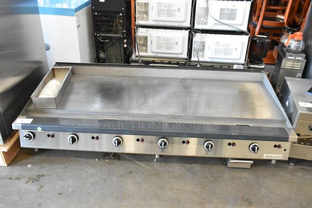 Garland stainless steel commercial countertop flat top griddle with multiple control knobs, in good condition.
