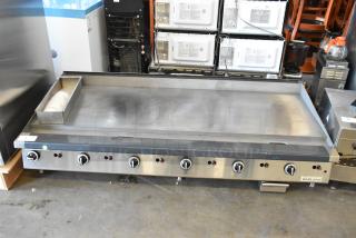 Garland stainless steel commercial countertop flat top griddle with multiple control knobs, in good condition.