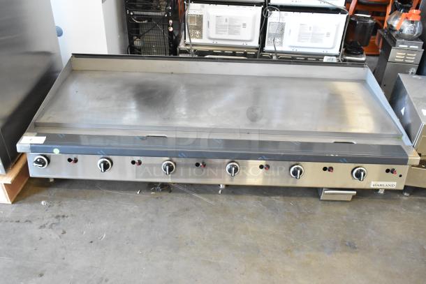 Garland stainless steel commercial countertop flat top griddle with multiple control knobs, in good condition.