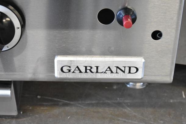 Garland stainless steel commercial countertop flat top griddle, close-up of control panel with brand logo.