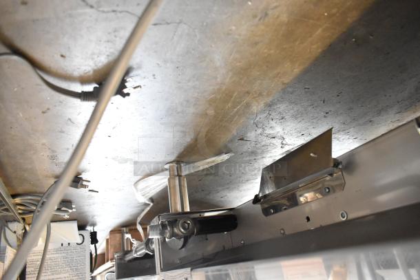 Garland stainless steel commercial countertop griddle, flat top, shown from underneath, wiring and components visible.