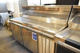 Delfield stainless steel commercial prep table on casters, 115 volts, 1 phase, in good condition, with visible brand logo.