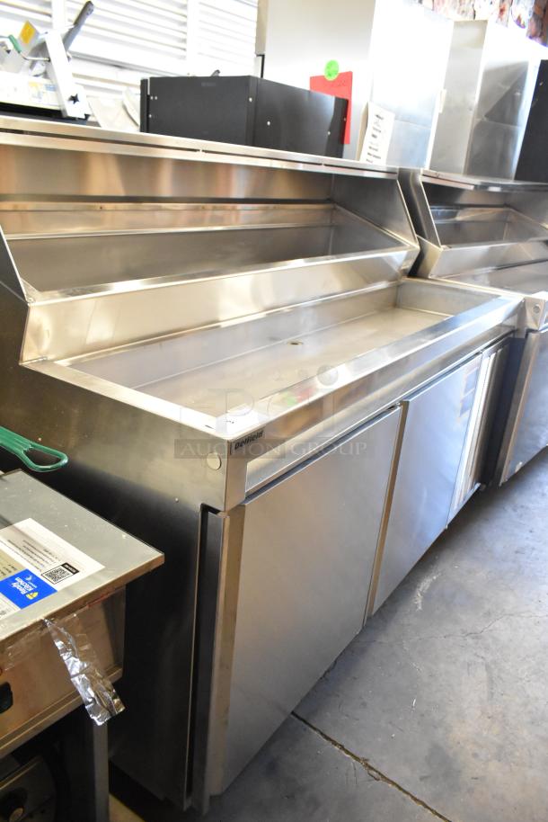 Delfield stainless steel commercial prep table on casters, 115 volts, 1 phase, excellent condition, features storage and workspace.