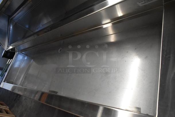 Delfield stainless steel commercial prep table with casters, 115V, 1 phase, in used condition, featuring spacious counter.