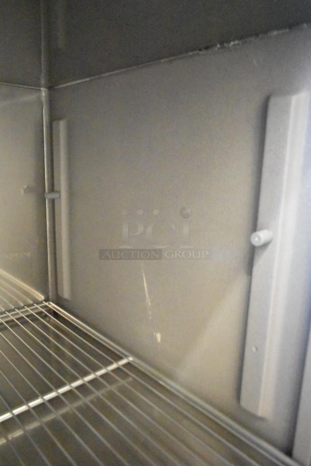 Delfield stainless steel commercial prep table interior, featuring wire shelving. 115 volts, 1 phase. Commercial casters included.