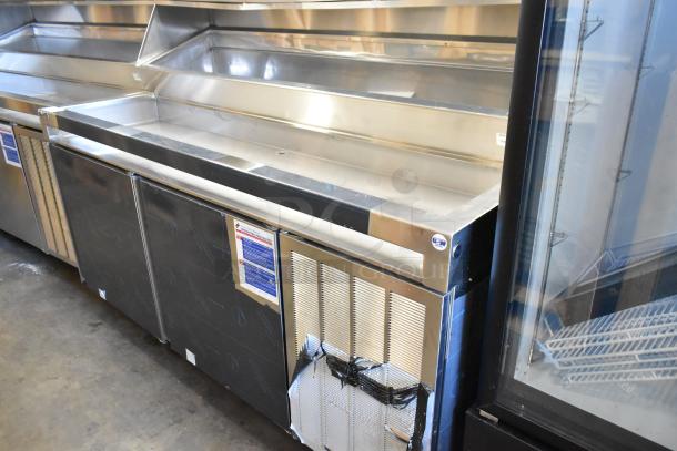 Delfield stainless steel commercial prep table, 115V, 1 phase, on commercial casters. Clean surface, minimal wear.