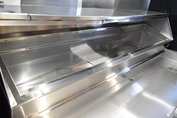 Delfield stainless steel commercial prep table with casters, 115 volts, 1 phase, in excellent condition.