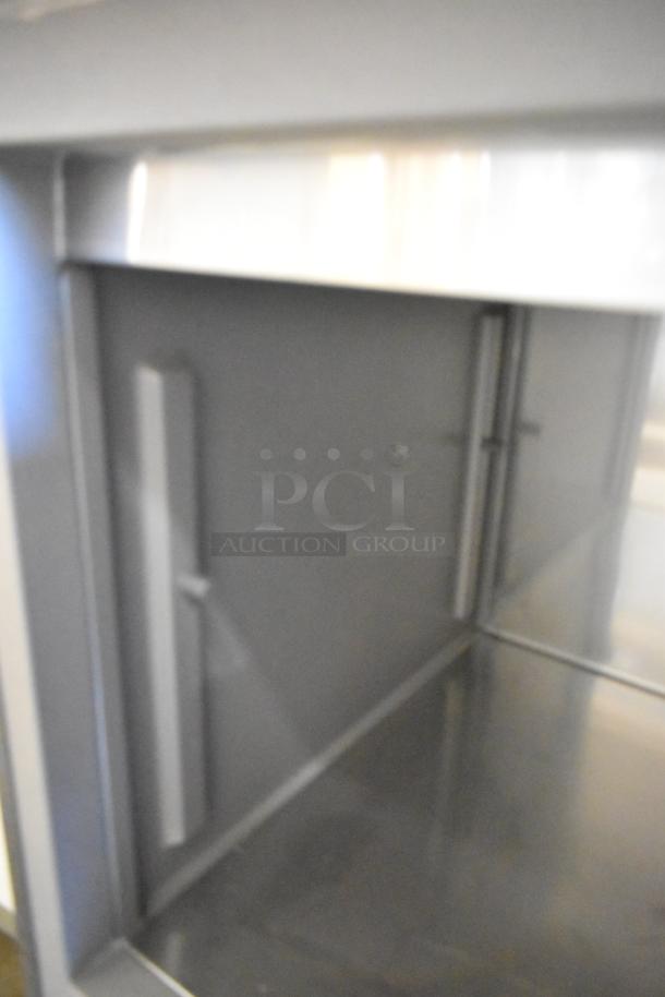 Delfield stainless steel commercial prep table, 115 volts, 1 phase, on commercial casters, excellent condition.