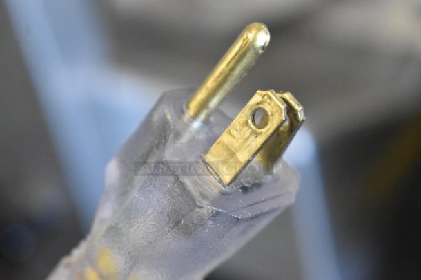 Close-up of a 115-volt plug on a Bizerba GSP HD commercial meat slicer. Clear prongs, in good condition.